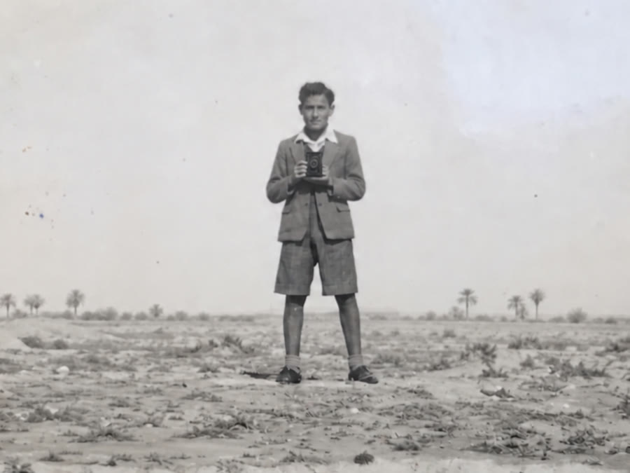 My grandfather Isaac at thirteen in 1940s Baghdad, holding a camera